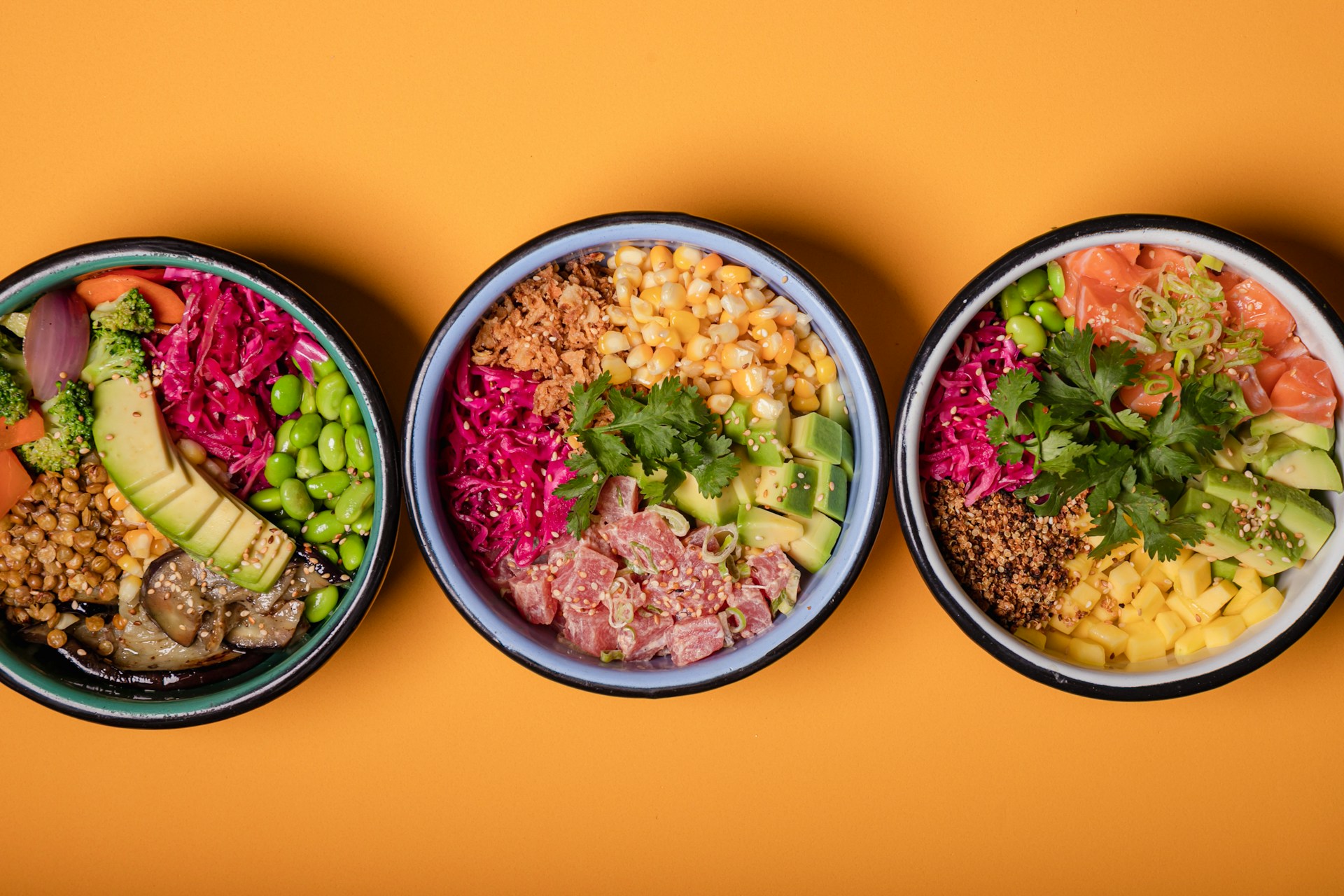 Three colorful personalized meal bowls